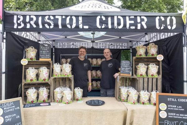 Mark and Jon running the cider stand at a food and drink festival.