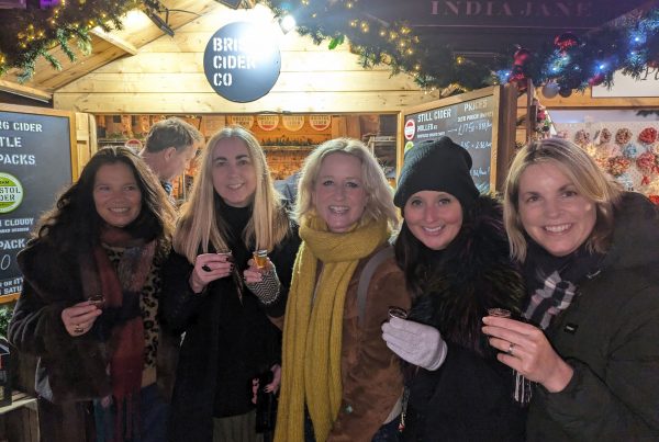 Customers sampling ciders in front of the Bristol Cider stall at Bath Christmas Market