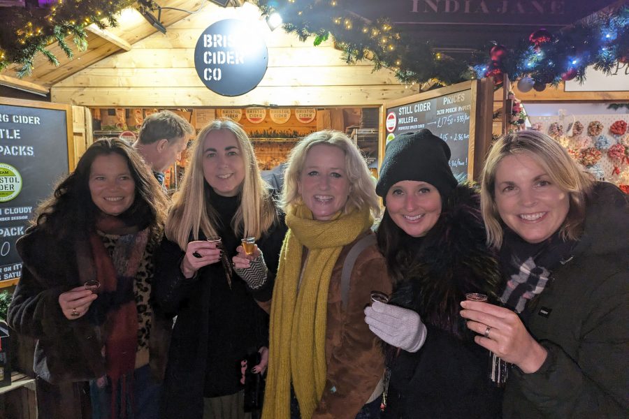 Customers sampling ciders in front of the Bristol Cider stall at Bath Christmas Market