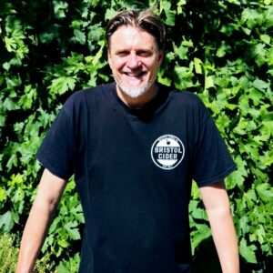 A man wearing a black t-shirt with a Bristol Cider logo